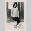 Young Japanese American woman in coat and skirt (ddr-densho-362-25)