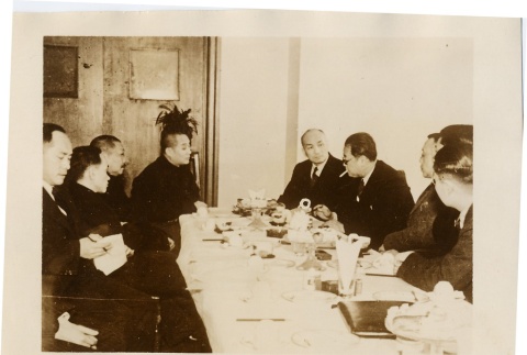 A group of men seated at a table (ddr-njpa-6-3)