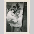 Four men work building ship models (ddr-densho-37-1355)