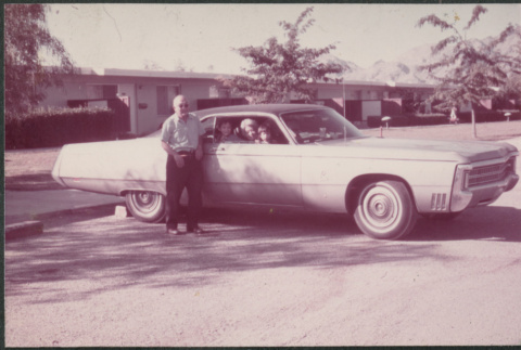 Man standing next to car (ddr-densho-523-604)
