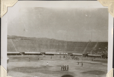 Men on field inside stadium (ddr-densho-466-730)
