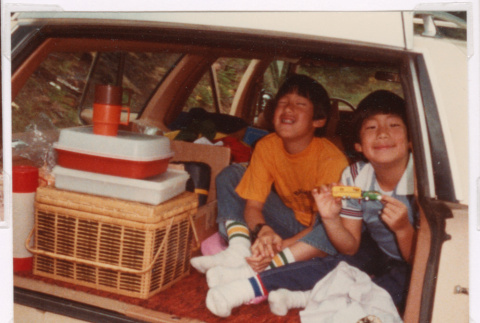 Scott and David Nishimura in the back of a car (ddr-densho-477-497)