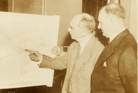 Carl Vinson reviewing a map with another man (ddr-njpa-1-2319)