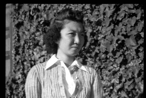 Mae Miwa in front of ivy-covered wall (ddr-densho-475-93)