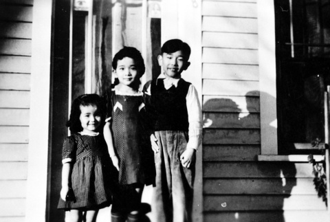 Three children on a porch (ddr-densho-5-7)