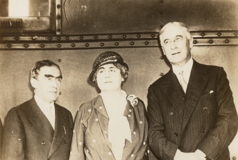 A woman and two men posing for a photograph (ddr-njpa-1-2424)