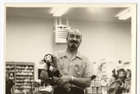 Man holding a toy (ddr-densho-542-797)