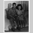 Pair sitting on couch (ddr-densho-1007-54)