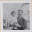 Man holding Leslie Shiomi (ddr-densho-522-403)
