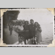 Man standing on walkway by lake with three women (ddr-densho-466-739)