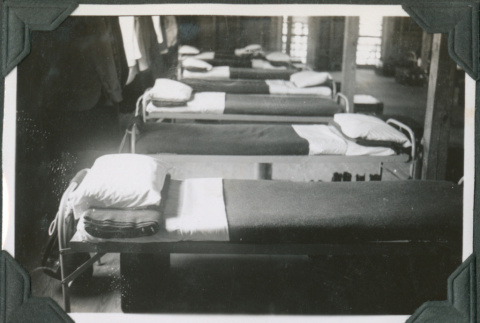 Row of cots in barracks (ddr-ajah-2-382)