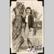 Woman standing by tree trunk (ddr-densho-587-46)