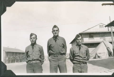 Three men in uniform outside barracks (ddr-ajah-2-132)