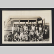 Photograph of Helen Muench with Japanese individuals in front of bus (ddr-csujad-55-2631)