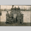 Group of men in uniform standing and sitting on wall (ddr-densho-434-500)