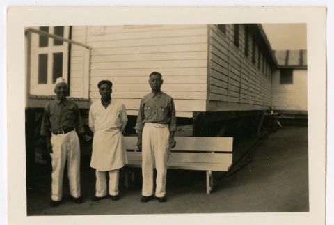 Three men standing in front of medical building (ddr-densho-223-16)