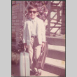 Boy in sunglasses and suit, carrying violin case (ddr-densho-523-586)