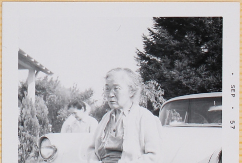 Woman standing by car (ddr-densho-522-428)