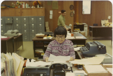 Woman seated in office (ddr-densho-426-141)