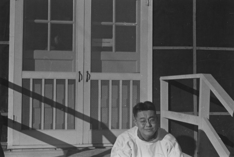 Incarceree in front of barracks at unidentified incarceration camp (ddr-csujad-14-26)