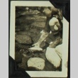 Boy holding fish above river (ddr-densho-201-331)