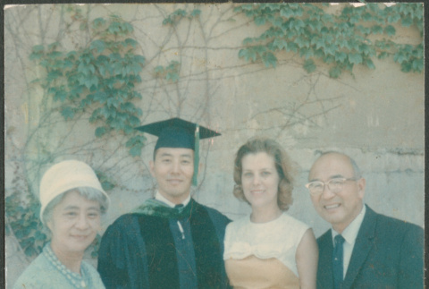 Man in graduation robe with Agnes and Chester Sakura and another woman (ddr-densho-523-428)