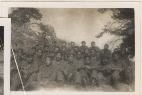 Large group of soldiers sitting on hillside (ddr-densho-466-255)