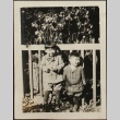 Two Nisei brothers in front of a fence (ddr-densho-259-82)