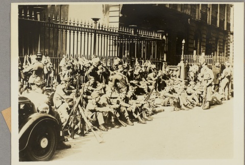 A group of soldiers sitting on a city sidewalk (ddr-njpa-13-1514)