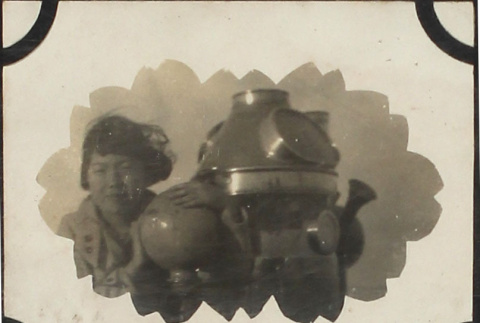 Girl standing next to machine (ddr-densho-423-505)