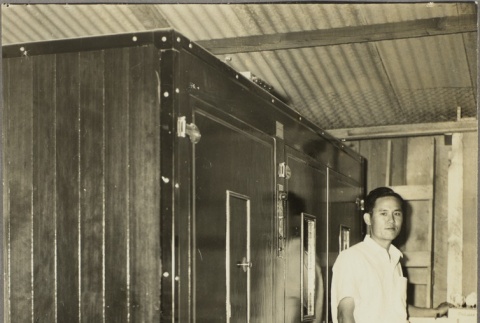 Mikio Asagi in front of a chicken hatchery incubator (ddr-njpa-5-74)