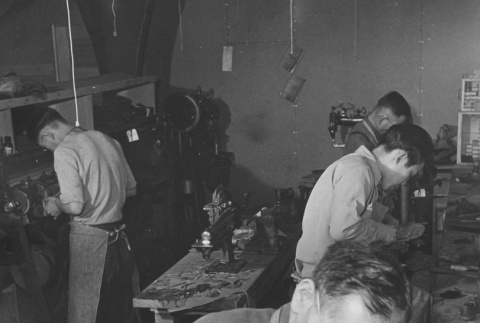 Shoemakers at work in shoe repair shop at Heart Mountain incarceration camp (ddr-csujad-14-60)