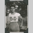Man wearing Minnesota t-shirt leaning on fence (ddr-ajah-2-575)