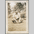 Man sitting on grass (ddr-densho-316-226)
