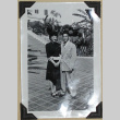 A couple poses in front of palm trees (ddr-densho-359-1653)
